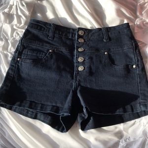 High-waisted navy shorts.